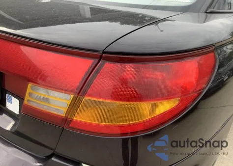 1999 Saturn Sc1 z USA, uszkodzony, nr VIN 1G8ZP1283XZ324457